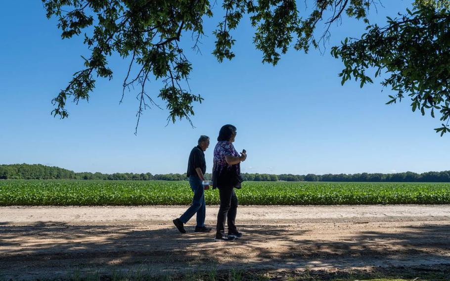 Mits Yamamoto, 98, walks with his daughter Ginny Syphx on the site of the the Jerome Incarceration camp in June in Arkansas. He lived there during the duration of World War II.