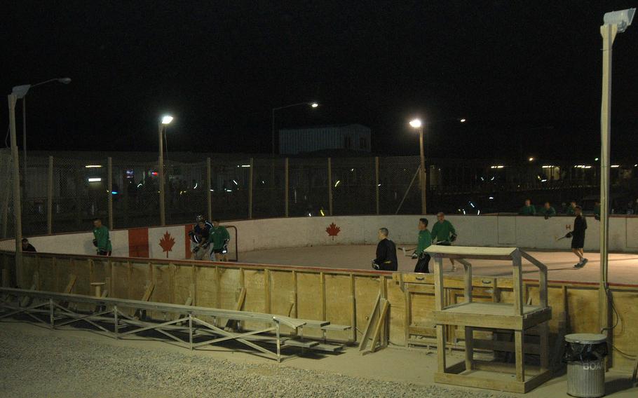 American service members scrimmage against each other in preparation for the upcoming ball hockey season at Kandahar Air Field in southern Afghanistan. The rink is one of the unusual sights at the KAF boardwalk, where visitors and residents can shop or dine at about two-dozen shops and restaurants, or play a variety of sports in the common area in the middle of the boardwalk square.