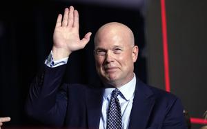 Matt Whitaker, the former acting attorney general and potential ambassador to NATO in President-elect Donald Trump’s second term, raises a hand and smiles, Des Moines, Iowa, Jan. 15, 2024.