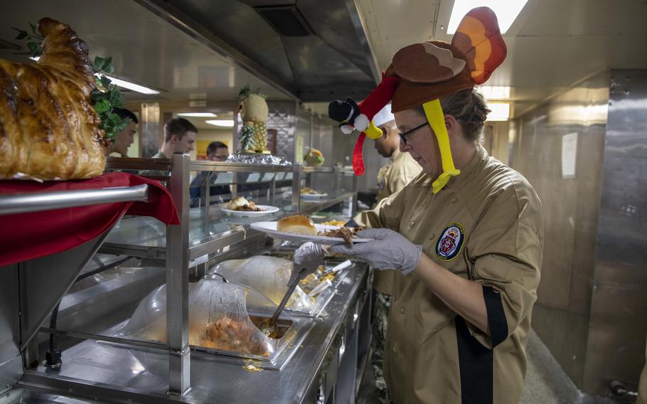 Capt. Kathryn Elliott serves Thanksgiving dinner to the crew of the hospital ship USNS Comfort in the Caribbean Sea on Nov. 22, 2022. 