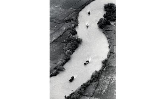 HED: Rolling down the river, 1967

South Vietnam, May, 1967: Moving in a tactical formation, South Vietnamese Army "rag boats" ferry U.S. troops from the 25th Infantry Division down the Saigon River on the edge of the Boi Loi Woods, near Cu Chi, during Operation Manhattan. The World War II-vintage boats dropped the patrols off at hard-to-reach places along the river where enemy troops might be hiding.

Looking for Stars and Stripes’ coverage of the Vietnam War? Subscribe to Stars and Stripes’ historic newspaper archive! We have digitized our 1948-1999 European and Pacific editions, as well as several of our WWII editions and made them available online through https://starsandstripes.newspaperarchive.com/

META TAGS: Vietnam delta; Vietnam War; U.S. Army; Operation Manhattan; Vietnamese navy;  