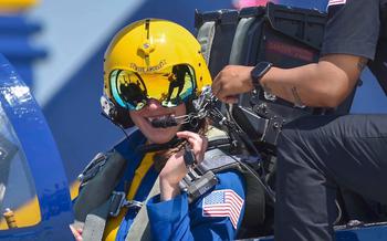 A video screen grab shows Navy Blue Angels pilot Lt. Cmdr. Amanda Lee in her flight gear.