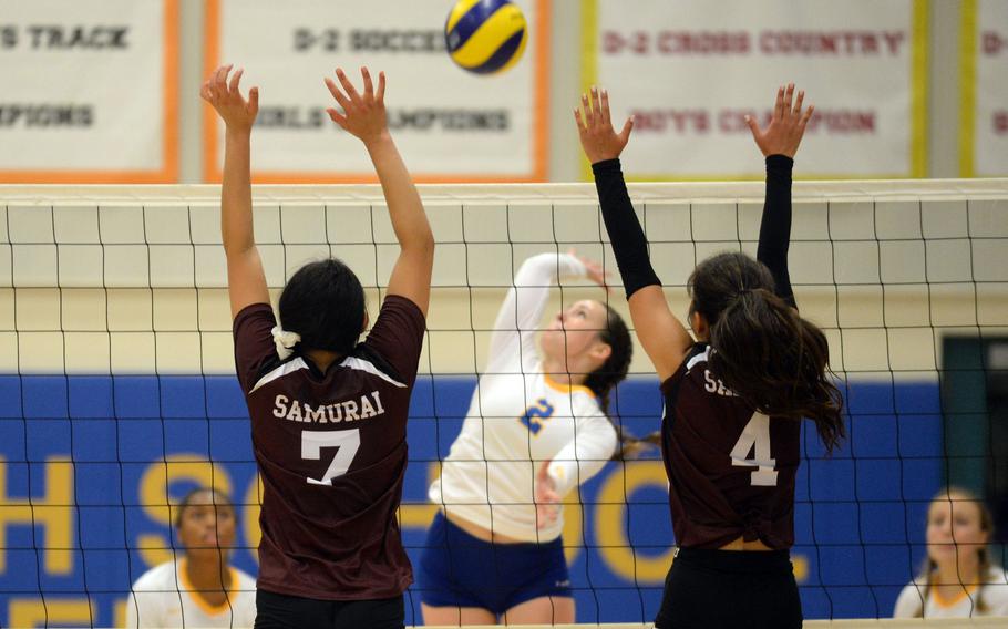 Yokota's Malia Hutchins readies to hit against the double block of Matthew C. Perry's Raelin Reyes and Towa Albsmeyer during Friday's DODEA-Japan girls volleyball match. The Samurai rallied from two sets down to win in five sets.