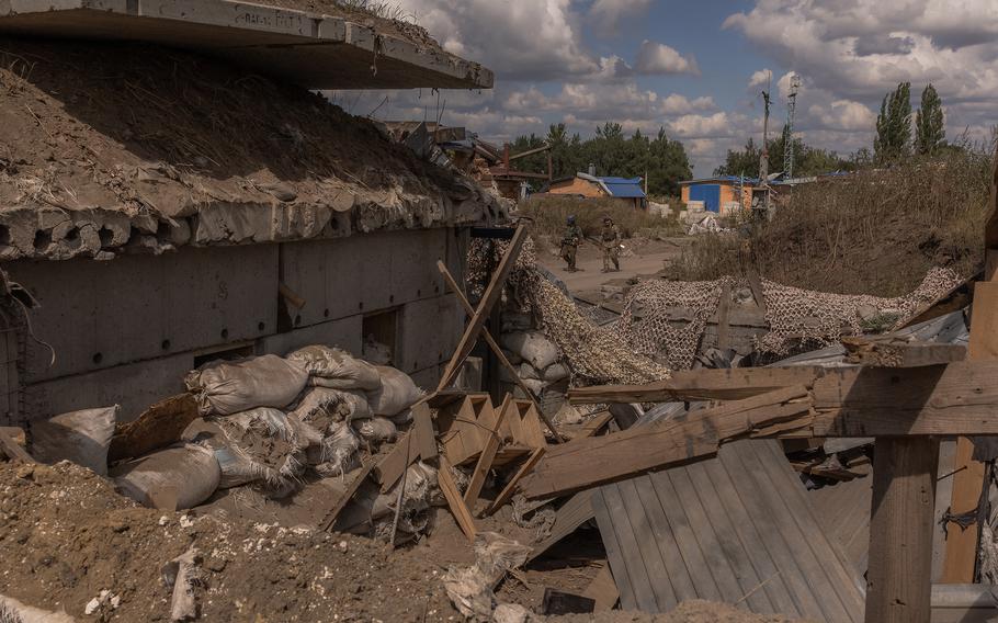 Ukraine troops guard an area at a destroyed border crossing point with Russia, in the Sumy region, on Aug. 14, 2024, amid the Russian invasion of Ukraine. 