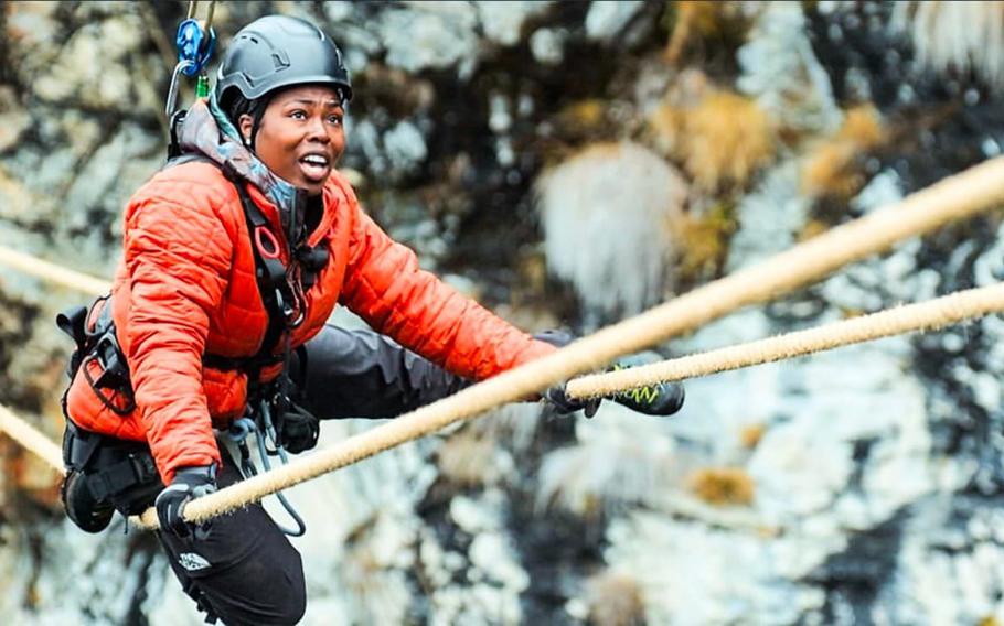 Ladeania Jackson climbs ropes on a mountain during a reality tv show competition.