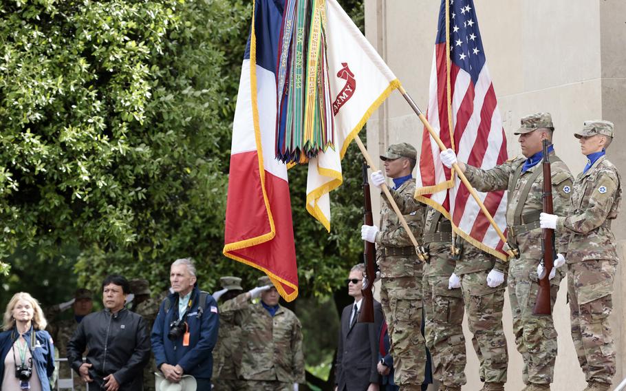 U.S. soldiers hold French and U.S. flags during the 78th anniversary of D-Day ceremony at the Normandy-American Cemetery and Memorial of Colleville-sur-Mer on June 6, 2022. The ceremonies pay tribute to the nearly 160,000 troops from Britain, the United States, Canada and elsewhere who landed on French beaches on June 6, 1944, to restore freedom to Europe after Nazi occupation. 