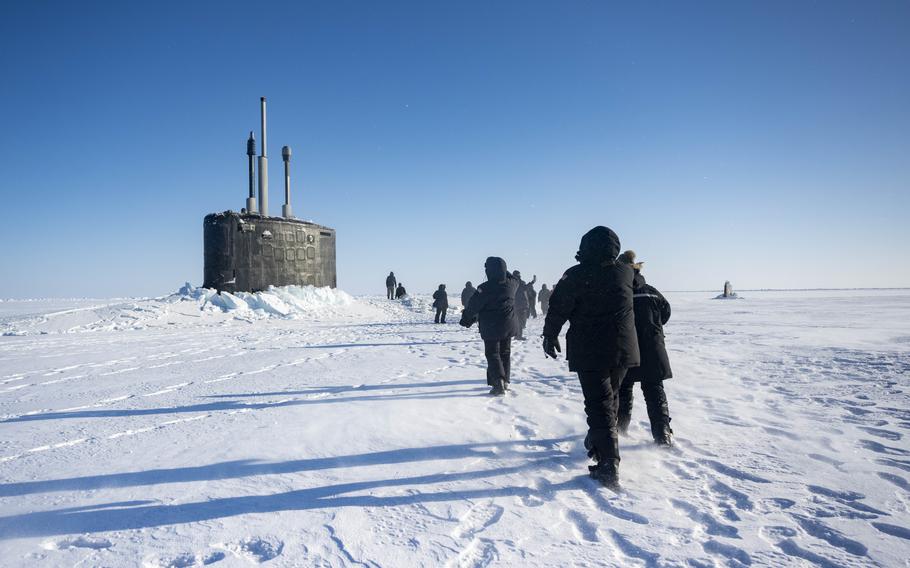 Adm. Lisa Franchetti, the chief of naval operations, walks with others towards the submarine USS Indiana during Operation Ice Camp 2024 in March 2024.