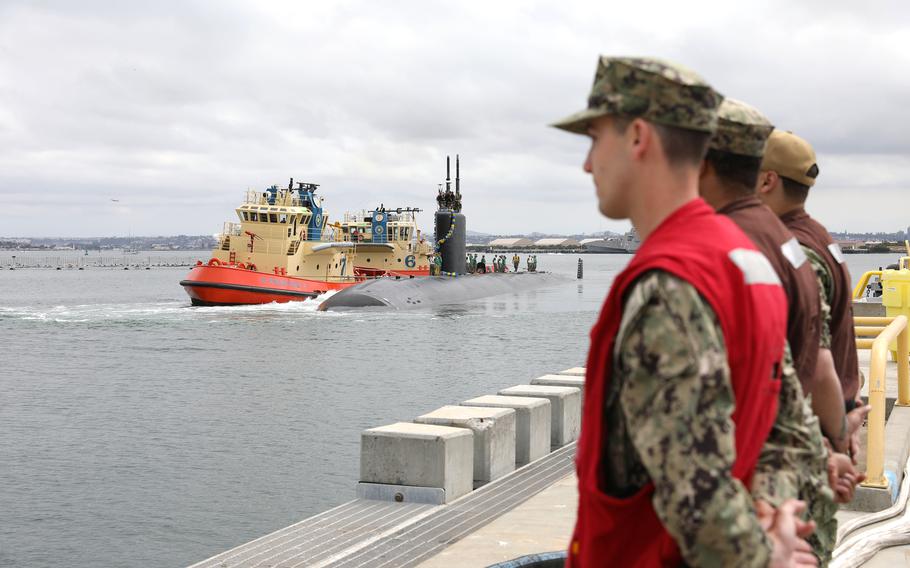 Sailors assigned to Commander Submarine Squadron 11 prepare to moor the Los-Angeles class fast-attack submarine USS Greeneville (SSN 772) as it arrives at its new homeport at Naval Base Point Loma, May 20, 2024. 