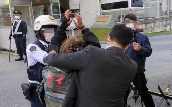 Anti-U.S. military base protester Akino Miyagi is arrested in front of the U.S. Consulate in Naha, Okinawa, Feb. 16, 2024, in this photo posted to her Facebook account.