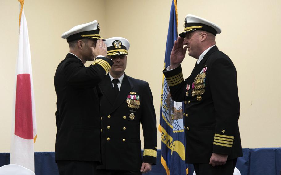 Capt. Joseph Parsons, left, takes command of the Navy’s support activities on Okinawa from Capt. Patrick Dziekan, right, during a ceremony at the Crow’s Nest Club on Camp Shields, Dec. 12, 2024.