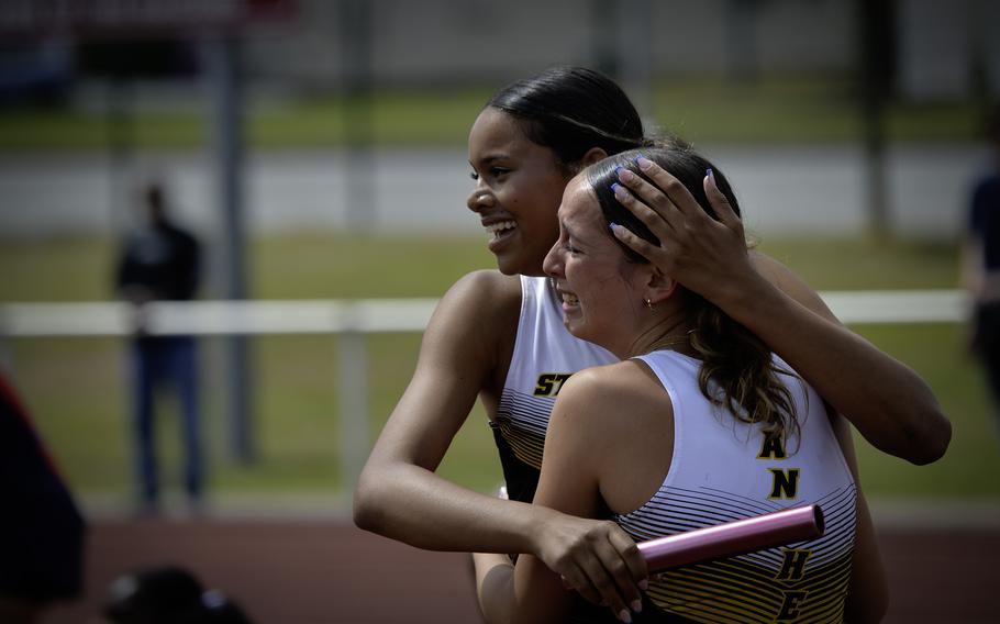 Stuttgart’s Anika Smith, left, embraces her teammate after their relay team’s victory with a time of 49.37 seconds at the 2024 DODEA European Championships at Kaiserslautern High School in Kaiserslautern, Germany, on May 24, 2024.