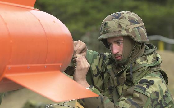 Army Spc. Dustin Lee, ordnance specialist, Battery 5 Battalion 5th Air Defense Artillery, Camp Casey, wires the engines of the Ballistic Aerial Target (BAT) for an electronic start at Chulmae Range, Korea, during Operation Sea Strike, Nov. 27, 2001.