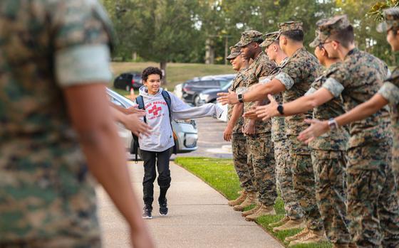 Students are greeted by Marines during a back-to-school celebration at the Quantico Middle/High School on Marine Corps Base Quantico, Virginia, Aug. 21, 2024. This event welcomed students back to the classrooms, provide extra motivation and well wishes as they start their first day of school following summer break. (U.S. Marine Corps photo by Lance Cpl. David Brandes)