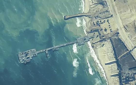 The image provided by U.S, Central Command, shows U.S. Army soldiers assigned to the 7th Transportation Brigade (Expeditionary), U.S. Navy sailors assigned to Amphibious Construction Battalion 1, and Israel Defense Forces placing the Trident Pier on the coast of Gaza Strip on May 16, 2024. A key section of the U.S. military-built pier designed to carry badly needed aid into Gaza by boat has been reconnected to the Gaza beach following storm damage repairs and aid will begin to flow soon, the U.S. Central Command announced Friday.