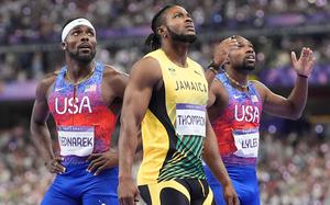 The United States' Kenny Bednarek, Jamaica's Kishane Thompson and Noah Lyles wait to find out who won the race. MUST CREDIT: Jabin Botsford/The Washington Post