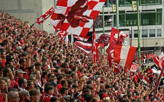 Supporters wave flags and cheer during an FC Kaiserslautern soccer game 