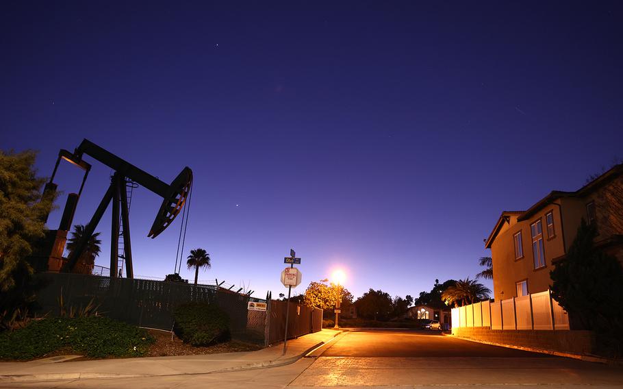 An oil pumpjack stands idle near homes on Feb. 9, 2023, in Signal Hill, California.