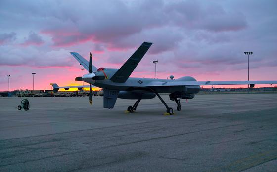 A remotely piloted MQ-9 Reaper from the 163rd Attack Wing sits in front ...