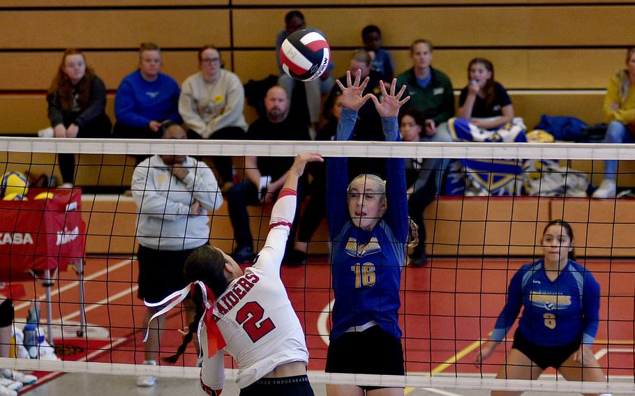 Wiesbaden's Lillie Redeen jumps to try to block a spike by Kaiserslautern's Bianca Ocampo during a match on Sept. 21, 2024, at Kaiserslautern High School in Kaiserslautern, Germany.