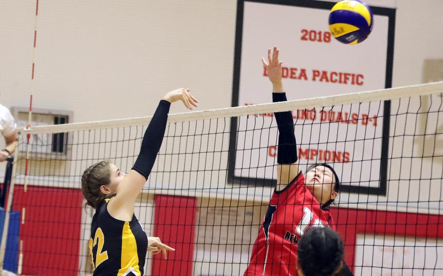 American School In Japan's Lily Stone-Borgeois hits the ball past Nile C. Kinnick's Kay Kim during Tuesday's Kanto Plain volleyball match. The Mustangs won in two sets.