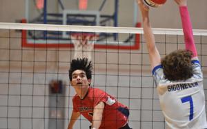 Aviano's Xavier Fox hits the ball through the block of Sigonella's William Thompson on Saturday, Oct. 5, 2024, at Aviano Air Base, Italy.