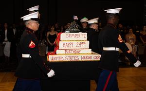 U.S. Marines with I Marine Expeditionary Force carry a cake commemorating the branch’s 249th birthday in Valley Center, Calif., Nov. 2, 2024.