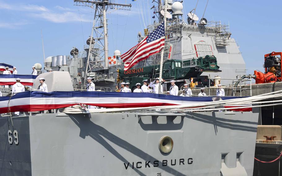 Sailors lower the ensign during the decommissioning ceremony of the guided-missile cruiser USS Vicksburg (CG 69), June 28, 2024, in Norfolk, Va.