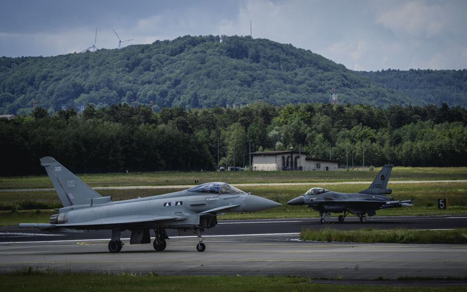 A British Eurofighter Typhoon taxis after landing at Ramstein Air Base, Germany, on June 6, 2024, followed by a Dutch air force Fighting Falcon. The "Ramstein 1v1" exercise aimed to practice joint flying and build trust between NATO pilots.
