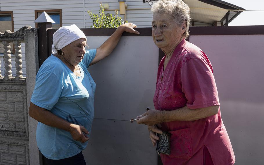 Valentina Okhrymenko locks the gate to her before home evacuating.