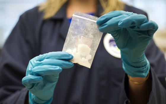 FILE - A bag of 4-fluoro isobutyryl fentanyl which was seized in a drug raid is displayed at the Drug Enforcement Administration (DEA) Special Testing and Research Laboratory in Sterling, Va., on Aug. 9, 2016. (AP Photo/Cliff Owen, File)