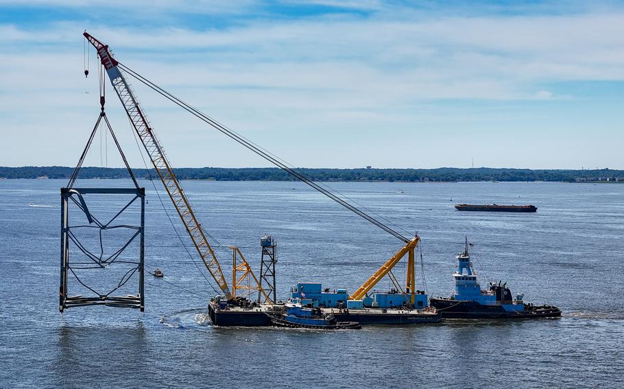 The Chesapeake 1000 crane barge carries a large section of the Francis Scott Key Bridge toward Tradepoint Atlantic as efforts continue to open the Federal Channel.