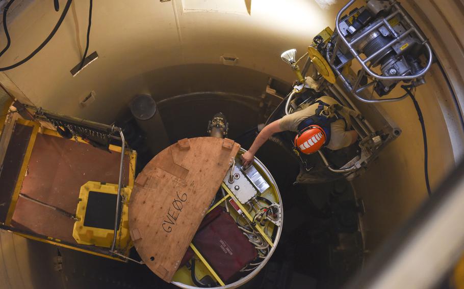 In this image provided by the U.S. Air Force, Airman 1st Class Jackson Ligon, 341st Missile Maintenance Squadron technician, examines the internals of an intercontinental ballistic missile during a simulated electronic launch Minuteman test Sept. 22, 2020, at a launch facility near Malmstrom Air Force Base in Great Falls, Mont. The Sentinel project, developed and managed by Northrop Grumman Corp., is meant to replace 1970s-era Minuteman III missiles