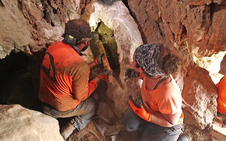 Removing the swords from the crevice where they were hidden. 