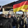 Protesters wave German flags and shout outside the main gate of Spangdahlem Air Base, Germany, on Nov. 24, 2024. The demonstration was the second one held since a Spangdahlem airman accused of killing German national Michael Ovsjannikov was acquitted last month.