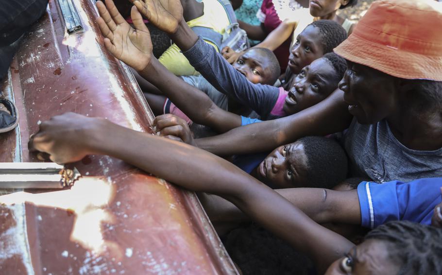 Haitians who had to leave their homes receive food.