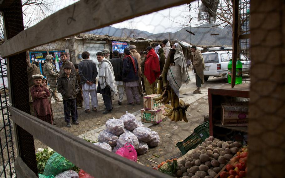 Soldiers of 2nd Platoon, Company B, 2nd Battalion, 27th Infantry Regiment, are swarmed by curious locals 