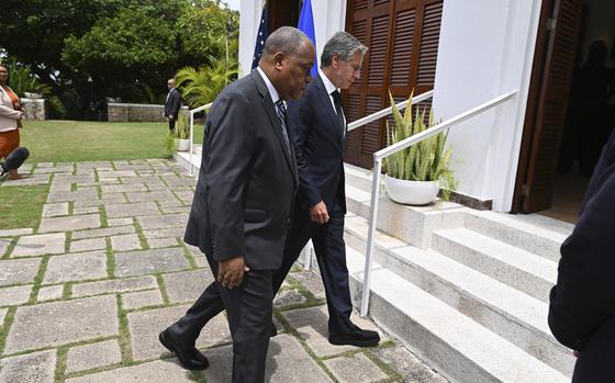 Haitian Prime Minister Garry Conille, front, and U.S. Secretary of State Antony Blinken enter the U.S. Chief of Mission Residence after speaking to the press in Port-au-Prince, Haiti, Thursday, Sept. 5, 2024. (Roberto Schmidt/Pool photo via AP)