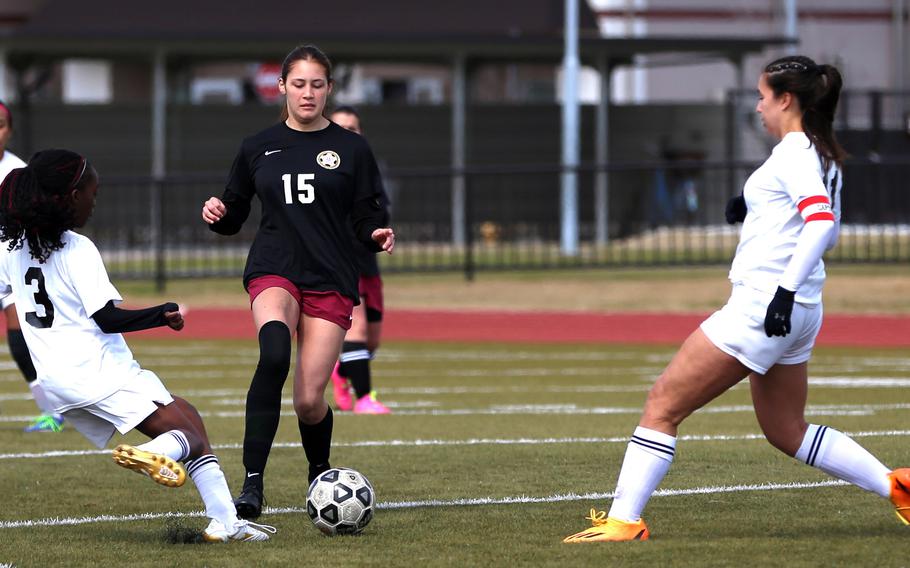 E.J. King's Tiffany Nabutete and Matthew C. Perry's Nevaeh Martinez try to play the ball as King teammate Maliwan Schinker moves in during Friday's Western Japan Athletic Association girls soccer match. The Samurai beat the defending champion Cobras 1-0.