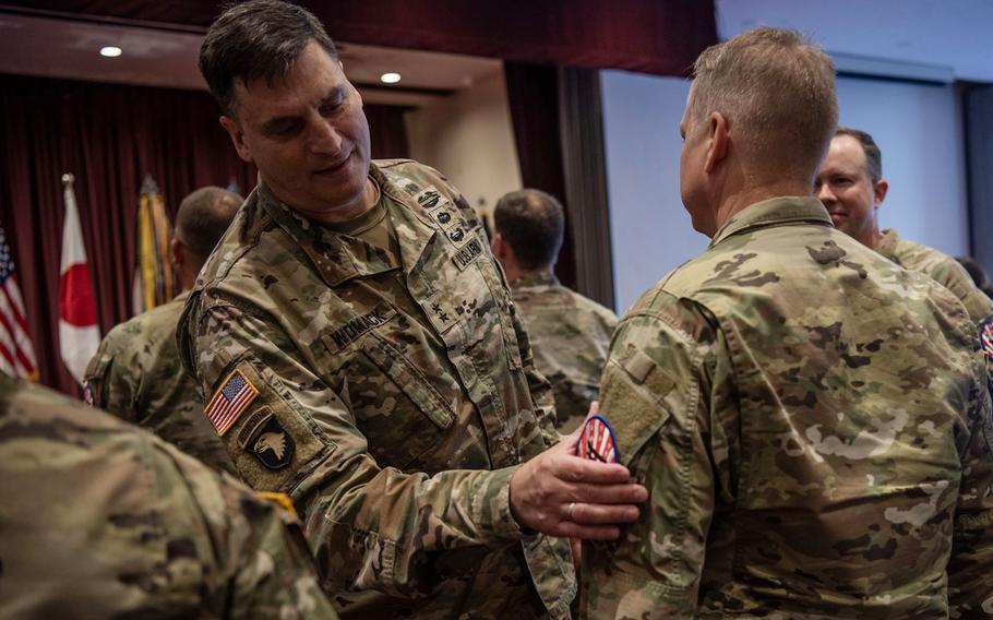 The commander of U.S. Army Japan, Maj. Gen. David Womack, presents soldiers with their new organization patches during a ceremony in the Officers' Club at Yokota Air Base, Japan, May, 20, 2024.