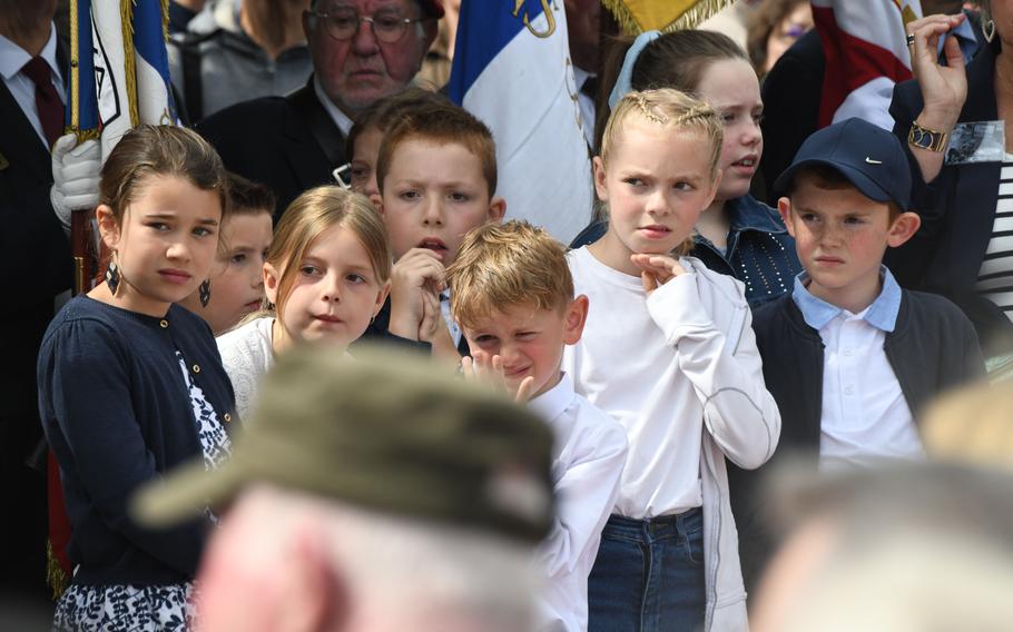 French children attend a ceremony in Sainte-Mère-Église, France, to honor Dwight D. Eisenhower, Monday, June 3, 2024. 