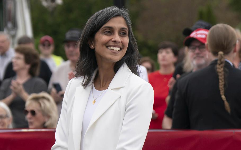 Usha Vance, wearing a white jacket, flashes a smile.