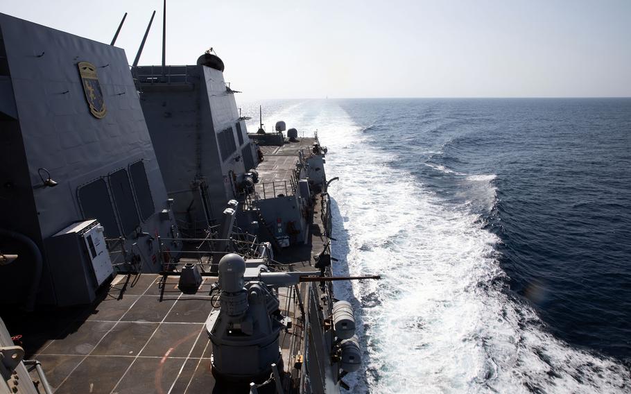 A U.S. naval destroyer transits the open water.