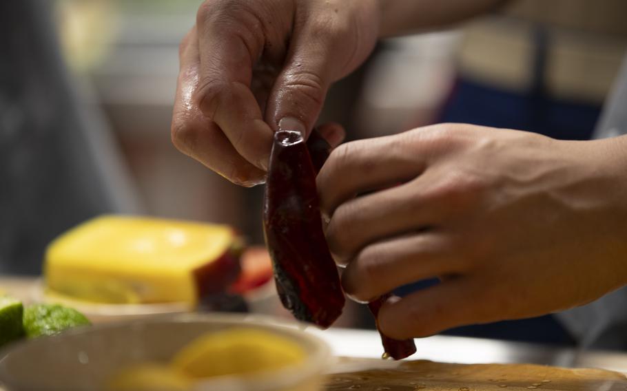 Culinary Specialist Seaman Ivan Barlow, from Virginia Beach, Virginia, prepares peppers