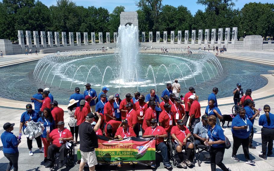 The 27 Black veterans and their chaperones participating in the first-ever honor flight to Washington to commemorate Juneteenth gather June 19, 2024, at the World War II Memorial for a photo.