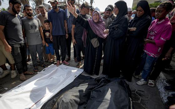 Palestinians mourn their relatives killed in the Israeli bombardment of the Gaza Strip in a hospital in Deir al-Balah, Sunday, July 21, 2024. (AP Photo/Abdel Kareem Hana)