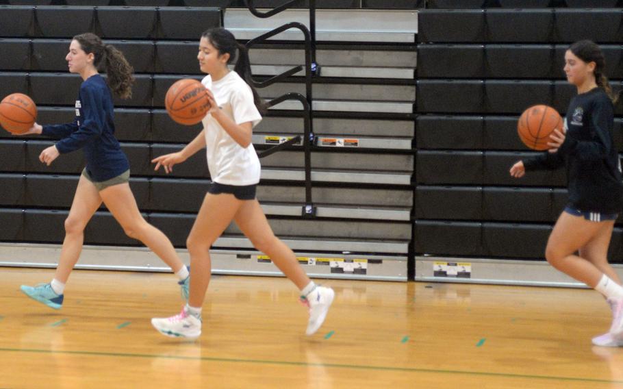 Kubasaki players dribble balls in basketball practice.