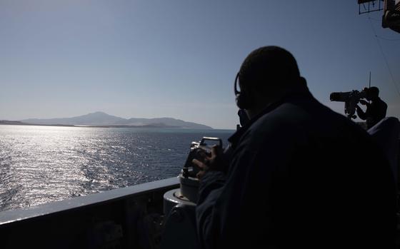 A Navy quartermaster looks through an alidade on the cruiser USS Gettysburg as the ship transits unspecified waters in the Middle East on Feb. 17, 2025. Iran-backed Houthi rebels in Yemen have refrained from targeting commercial ships since the Gaza ceasefire began in January, according to the Joint Maritime Information Center.