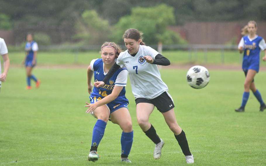 Sigonella's Isabelle Belleza takes a shot before Brussels' Kristen Baird can get to her in the Jaguars' 2-0 victory Tuesday, May 21, 2024, that guaranteed them a spot in the championship game of the DODEA European Division III girls soccer championships.