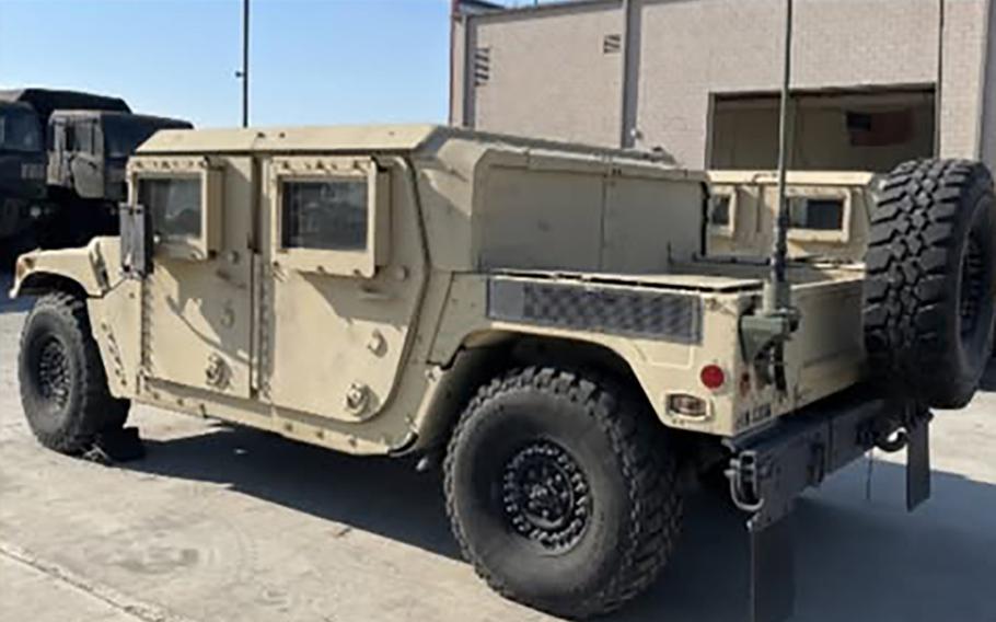 A Humvee rests outside on a sunny day.