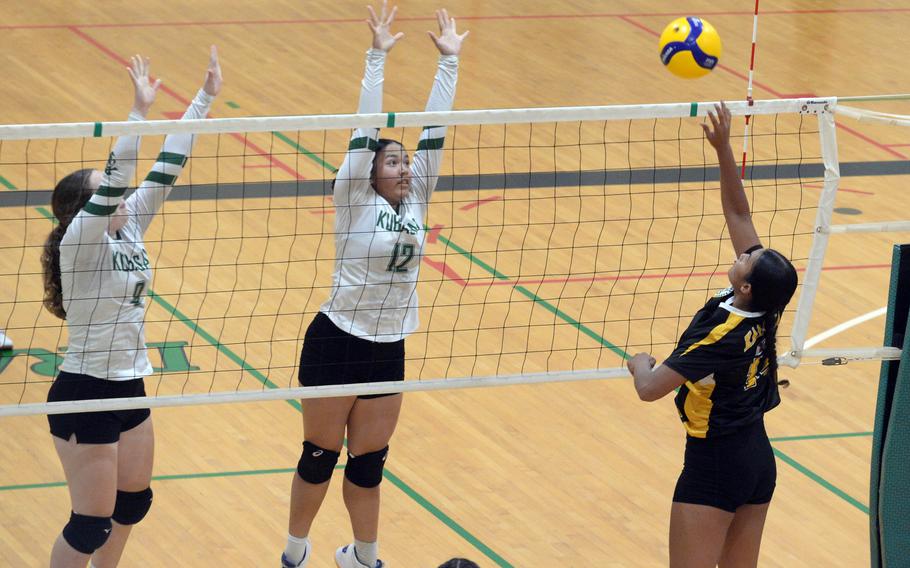 Kadena's Genesis Afaisen spikes against Kubasaki's Hailey Brassard and Ayeli Rocha during Tuesday's Okinawa girls volleyball match. The Panthers won in five sets.